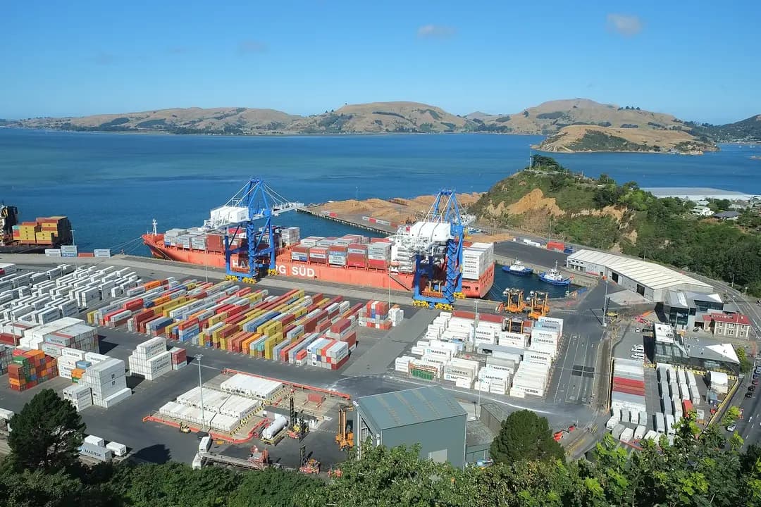Container ship and blue cranes at the Port Chalmers container terminal on Otago Harbour