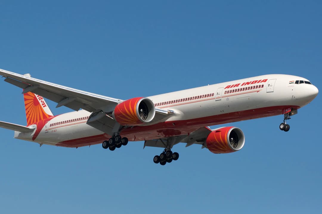 An Air India Boeing 777 coming in to land at Toronto Pearson airport against a blue sky